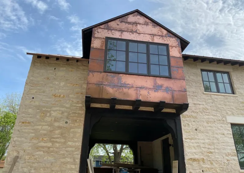Copper metal panel facade on a stone building for Skylight Installation in Martinsville